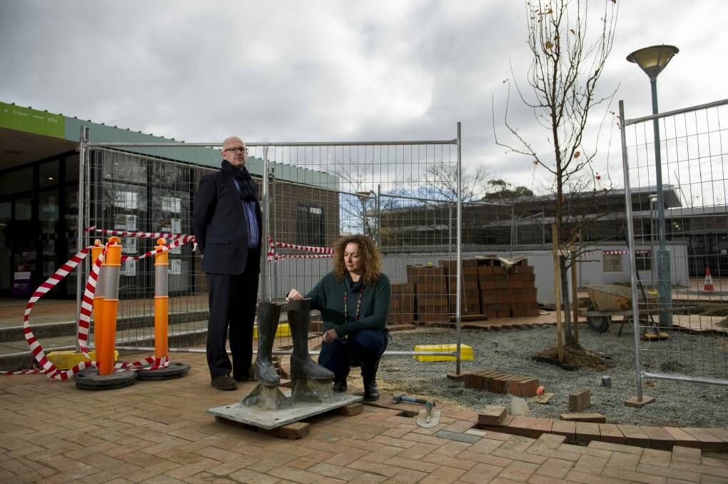 Cultural Canberra director Adam Stankevicius and artist Giovanna Ianniello with the  remainder of the stolen statue 'Stepping Out' at the Hughes shops. Photo: Jay Cronan