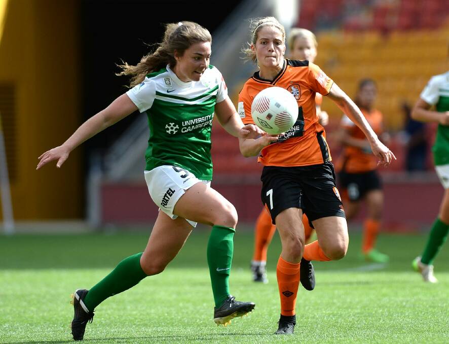 Canberra United defender Jenna McCormick challenges Brisbane Roar's Gabrielle Marzano for the ball. Photo: Bradley Kanaris