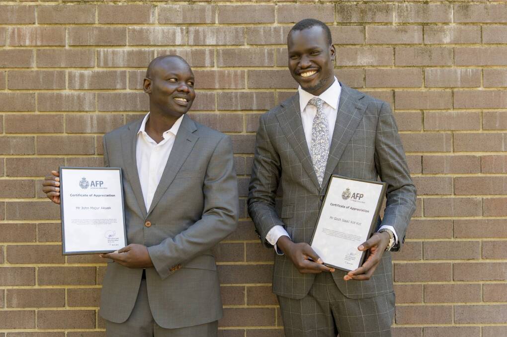 Taxi passengers John Akuak and Goch Kot received awards for their actions in stopping Imran Hakimi's attack. Photo: Jay Cronan