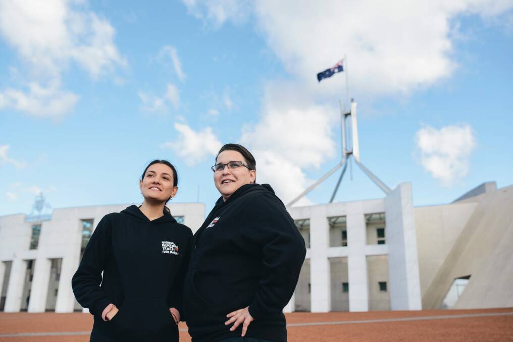 Talei Elu and Hope Davison outside parliament house. They are part a group of 50, involved in National Indigenous Youth Parliament. Photo: Rohan Thomson
