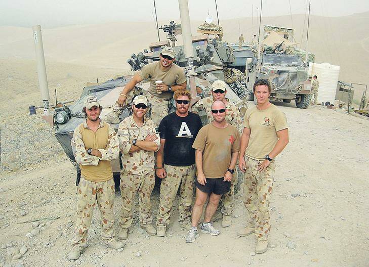 The ASLAV crews who took part in the action, with their vehicles. From left, Captain (then Lieutenant) Tim Hurley; Lance Corporal Somerton Lester; Trooper Michael "Nugget" McSorley (seated with cup); Corporal Dylan Preston (black shirt), who was the second ASLAV guncar commander; Corporal Michael Chatt (the Anar Joy Patrol Base medic); Lance Corporal Matt Pippin (with cap), Hurley's gunner; and Trooper Alex Roach, Hurley's driver. Photo: Defence