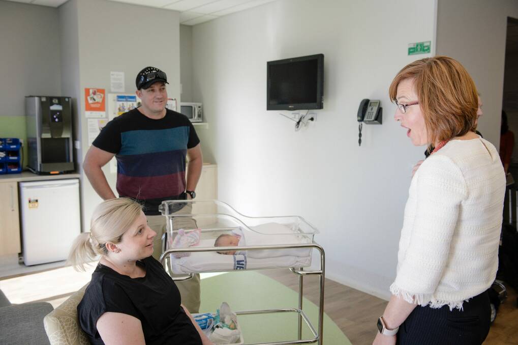 ACT Health Minister Meegan Fitzharris speaks to Anita and Nathan Linforth about their two-day-old baby Eden on Thursday. Photo: Sitthixay Ditthavong