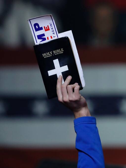 A supporter of Donald Trump holds a Bible during one of his rallies. Photo: AP