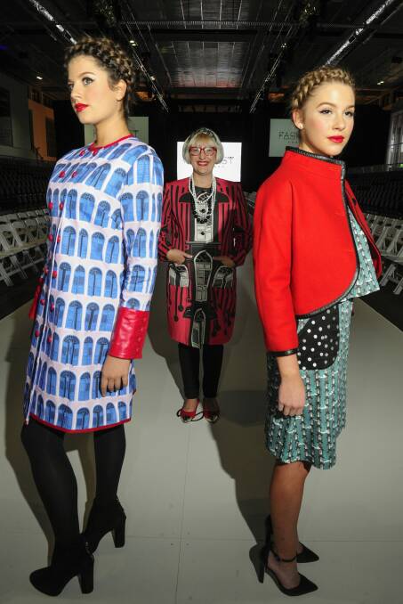 Fashion designer Mariska Thynne on the runway with models Emily Tokic, of O'Malley, and Angelina Leljak, of Gungahlin.