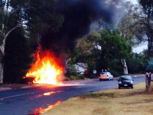 A car on fire on Dryandra St in O'Connor after being struck by lightning. Photo: Sarah Groube