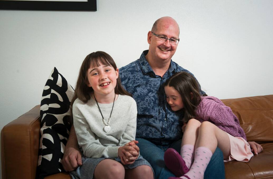 Scott Chamberlain at home in Campbell with his daughters Emma, 8, and Sophie, 6. Photo: Elesa Kurtz
