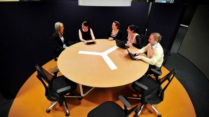 PricewaterhouseCoopers employees work in the new agility-based (shared-desk) workspace. Photo: Jay Cronan