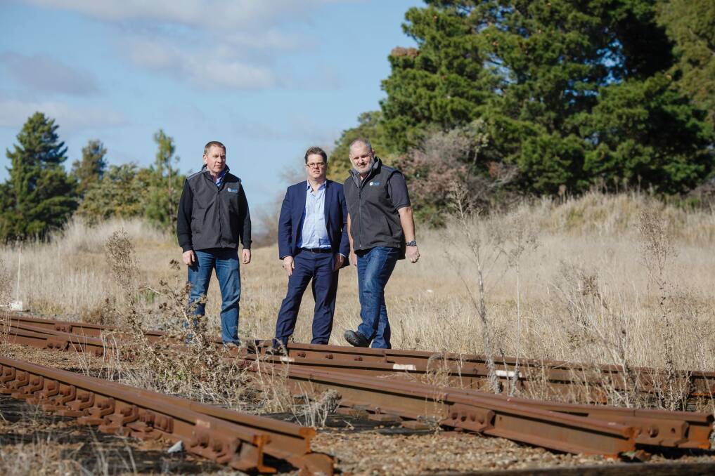 Director of Capital Recycling Solutions Adam Perry, Dean Ward from ActewAGL, and project manager Ewen McKenzie at the former Shell site, which planned to use the railway to export recyclables. Photo: Sitthixay Ditthavong