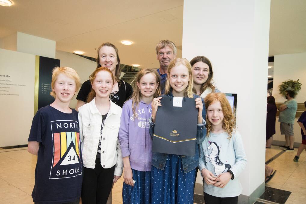 First coin strike winner Celeste Weerts with her family (from left) William Clissold, Emily Clissold, Sharon Clissold, Isabella Weerts, Trevor Weerts, Alicia Weerts and Isobelle Clissold at the Royal Australian Mint. Photo: Dion Georgopoulos