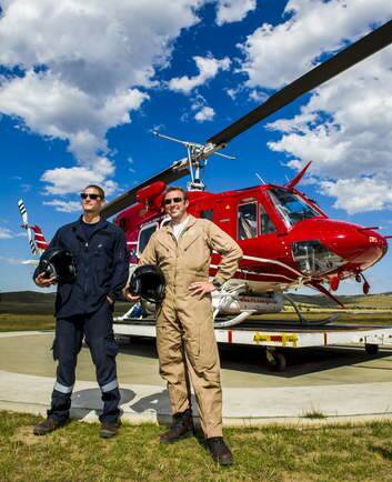 Rural Fire Services' helicopter pilots, Keith Kristian and Bruce Lilburn with one of the helicopters stationed at Hume. Photo: Rohan Thomson