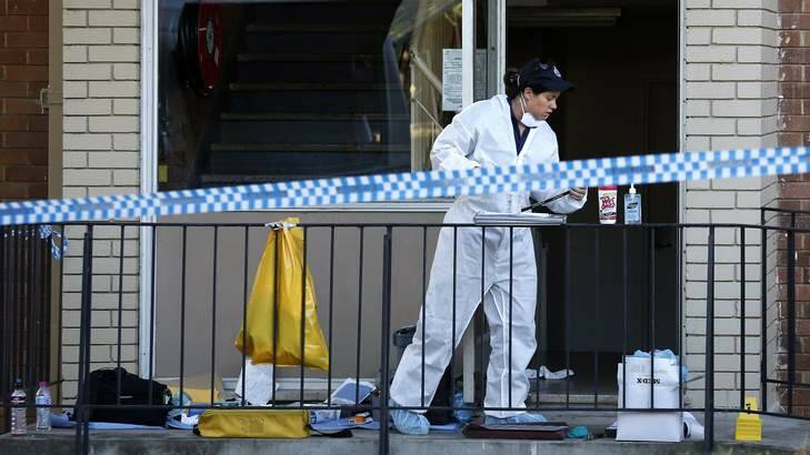 A forensics officer at work at the flats on Thursday. Photo: Jeffrey Chan
