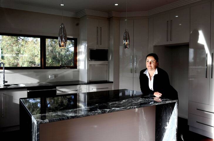 Exclusivity ... Luton senior property manager Tamara Davis in a Red Hill property which would set someone back $2500 a week to rent. Photo: Melissa Adams