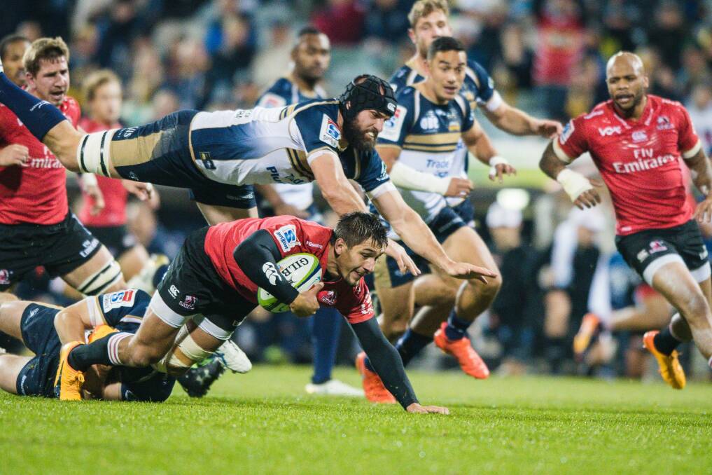 Brumbies flanker Scott Fardy tries to slow down a Lions opponent. Photo: Sitthixay Ditthavong