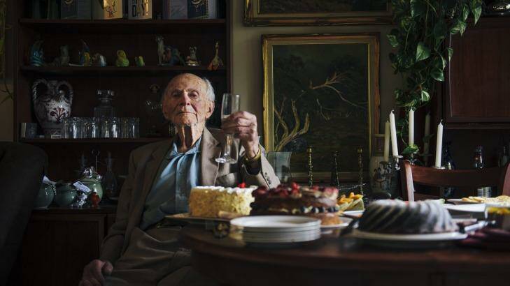Still going strong: Victor Lederer, who turned 100 on Tuesday, celebrates the occasion with a glass of wine and cake at home. Photo: Rohan Thomson