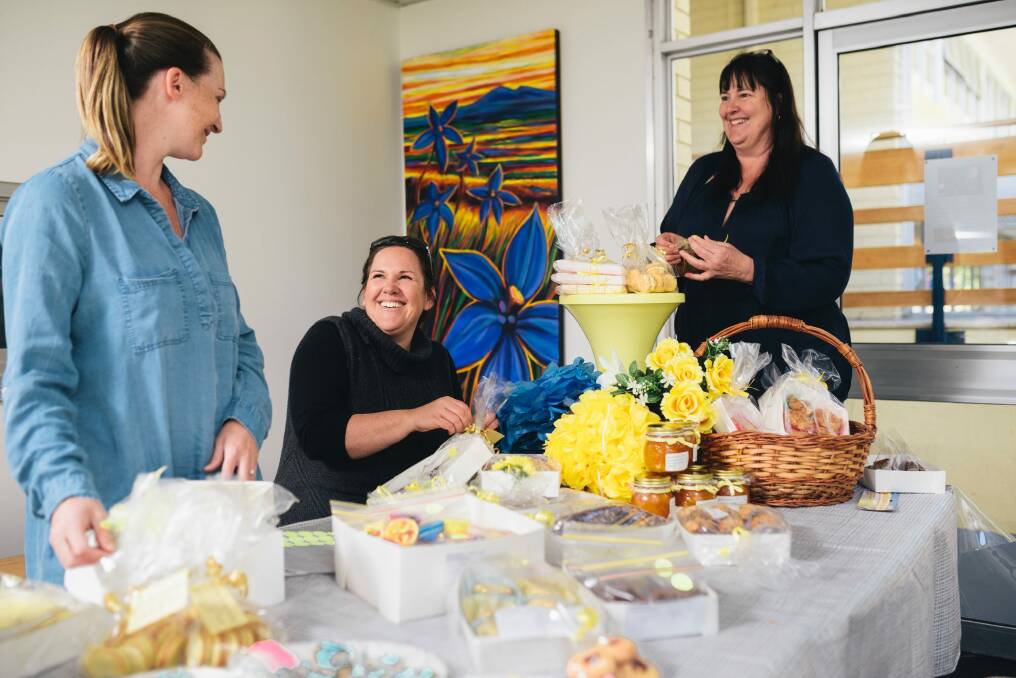 Melanie Allan, Alison Manners and Heather Frisken preparing items for sale at the Arawang primary school's 'Election Fun Day'. Photo: Rohan Thomson