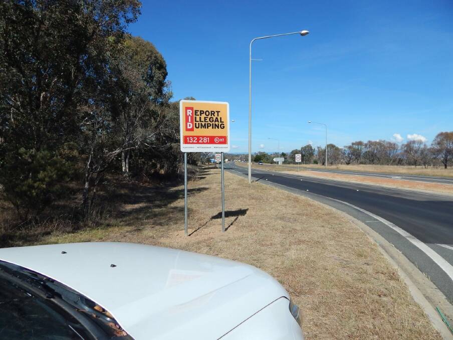 Roadside signs, including this one on the Barton Highway, have been installed to encourage residents to dob in dumpers. Photo: Supplied