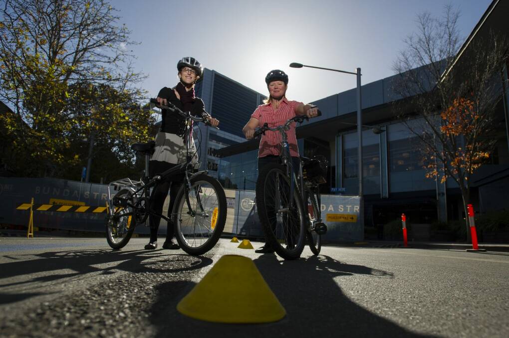 Renee Gallo and Raynie McNee prepare for the Bicycle Rodeo event to be held in Bunda Street on Sunday. Photo: Jay Cronan