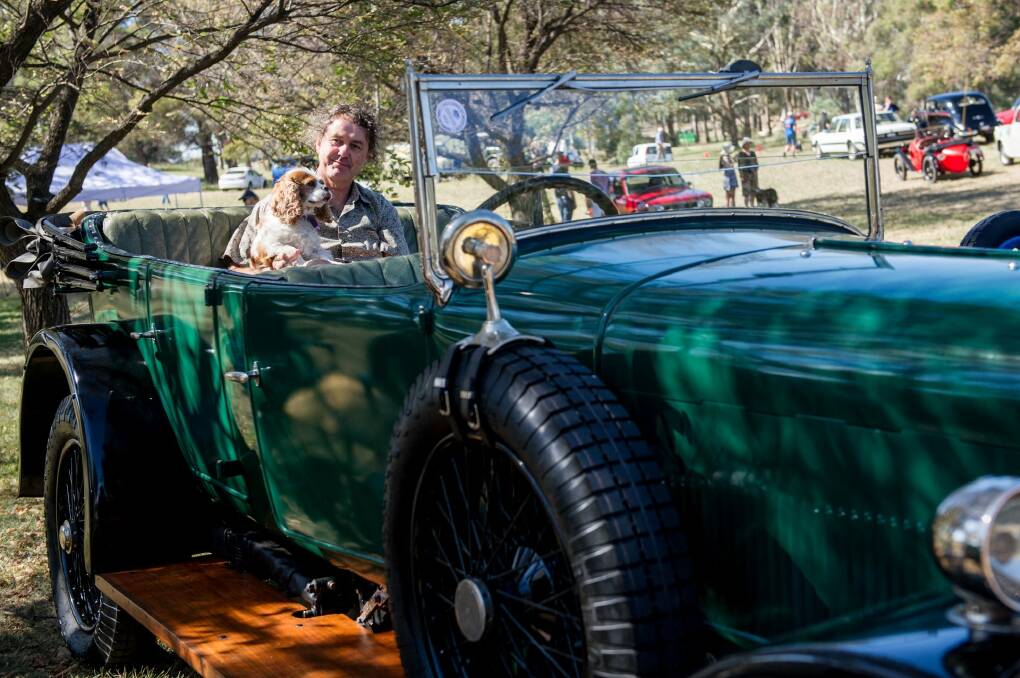 Ross Merdal with his dog in a 1924 Sunbeam at the ACT Council of Motor Clubs Wheels event in Kings park.
 Photo: Jay Cronan