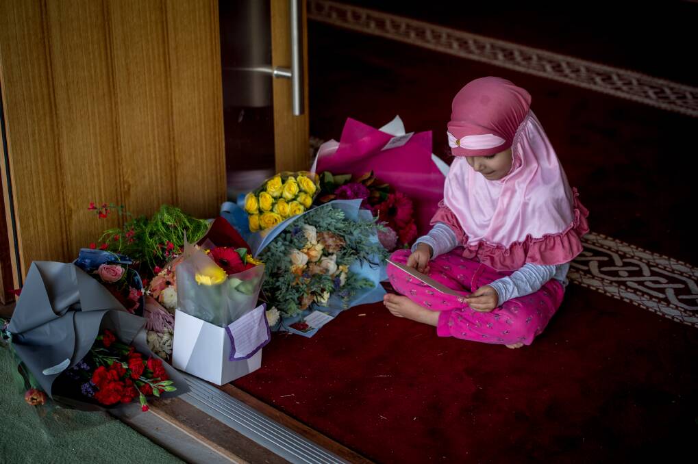 Alishiba Jadoon, 4 checks out the flowers and well wishes left by the Canberra community in support of their Muslim neighbours.  Photo: Karleen Minney