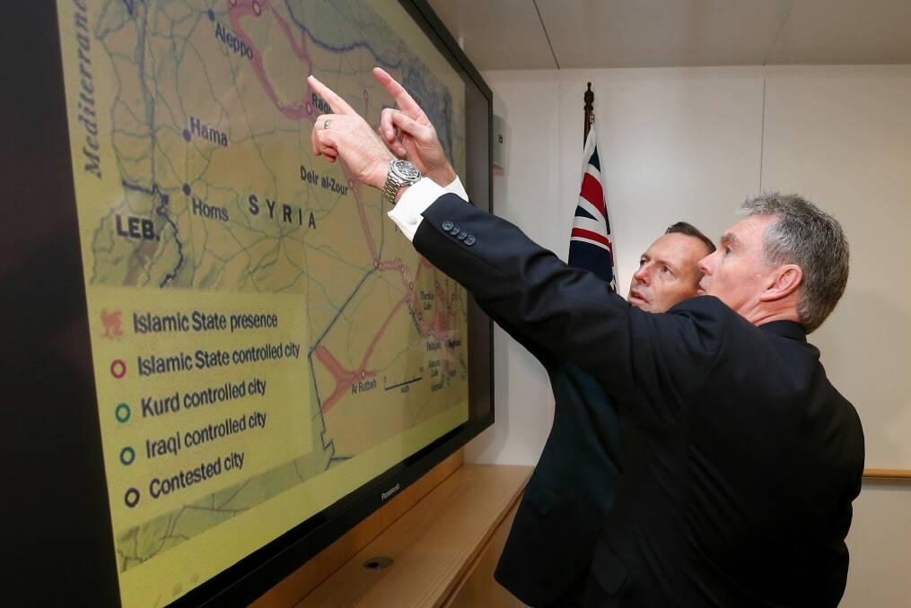 ASIO director-general Duncan Lewis gives a briefing to then prime minister Tony Abbott in June. Photo: Alex Ellinghausen
