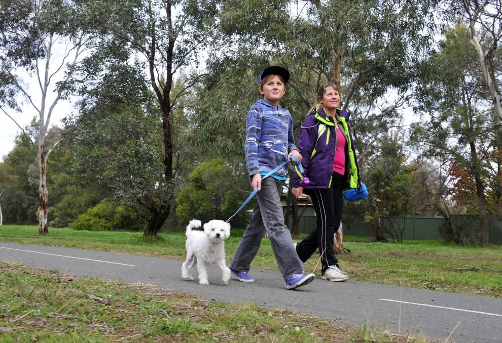 Kate Beach of Latham and her son Daniel walk their dog Bonnie through Charnwood. Photo: Melissa Adams
