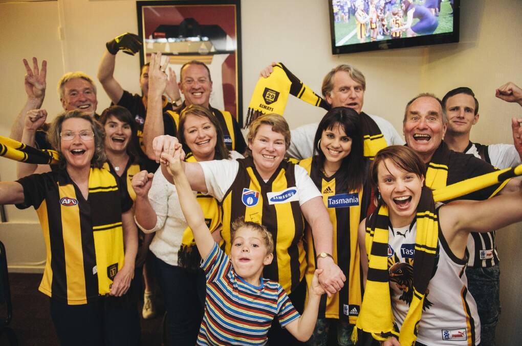 Hawks fans celebrate the AFL premiership win on Saturday afternoon at the Southern Cross Club in Phillip.

 Photo: Rohan Thomson