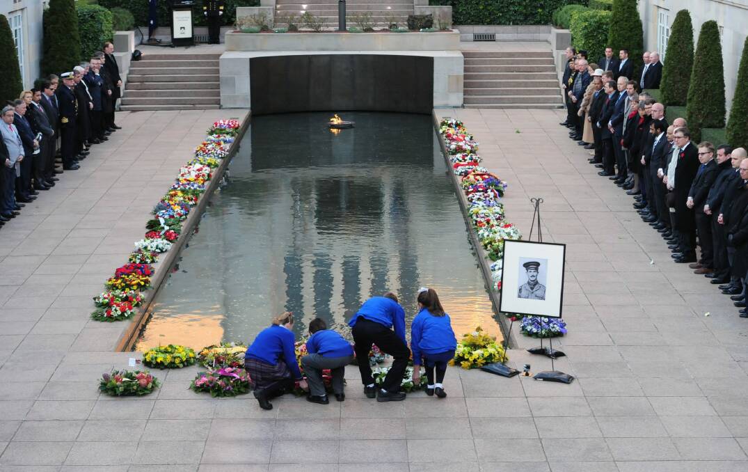 Wreaths are laid near the Pool of Reflection at the Australian War Memorial during a Last Post ceremony.
 Photo: Melissa Adams