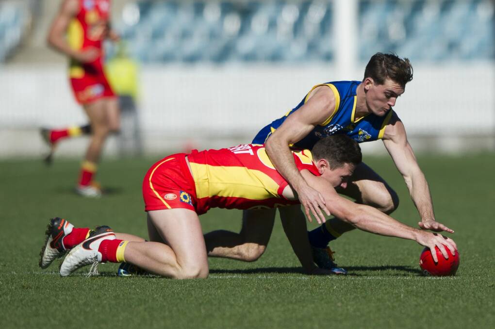 Demons player Sam Martyn and Suns player Danny Stanley go for the ball. Photo: Jay Cronan