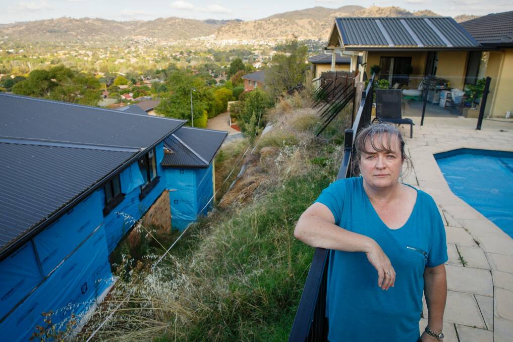 Suzi Maginnity has been battling for four years to have a secure retaining wall built to stop her property boundary eroding after an unauthorised excavation at the adjoining site.  Photo: Sitthixay Ditthavong