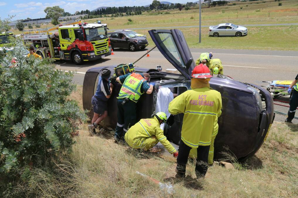 Emergency services attended a  car rollover on Canberra Avenue on Thursday afternoon. Photo: Darren Cutrupi