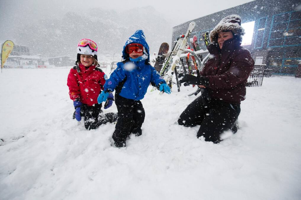 Louise Debenhan and her children Jessica and Oliver play in the snow at Thredbo.  Photo: Aedan O'Donnell