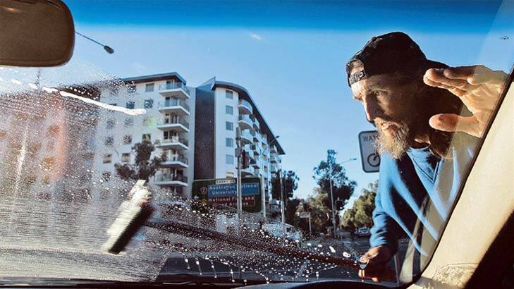 Window cleaner Lindsay at work on Northbourne Avenue, Civic. He attracts a mixture of appreciation and insults but the unkind words wash off. Photo: Andrew Sheargold