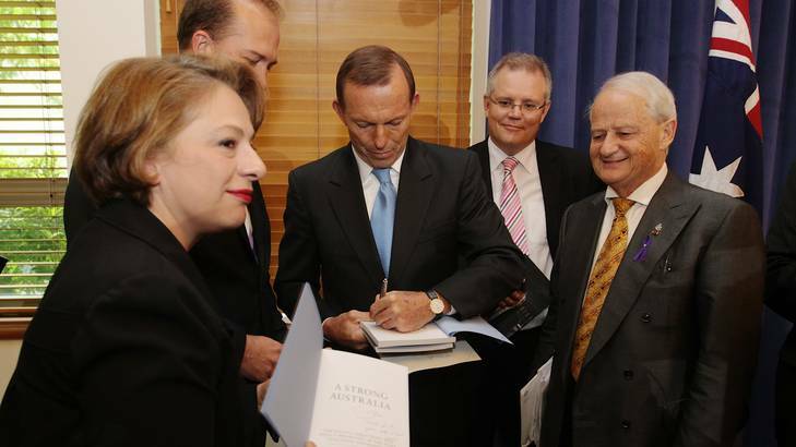 Opposition Leader Tony Abbott signs copies of his book, at the launch of his book, 'A Strong Australia', at Parliament House in Canberra on Wednesday. Photo: Alex Ellinghausen