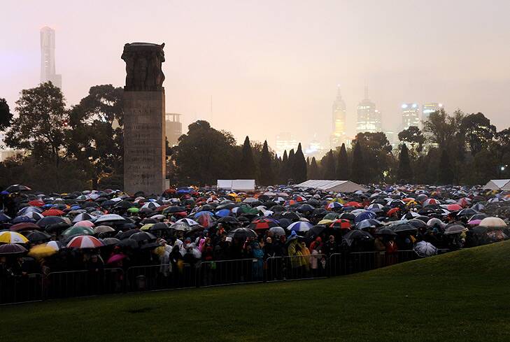 A sea of umbrellas as thousands pay their respects in the city. Photo: Penny Stephens