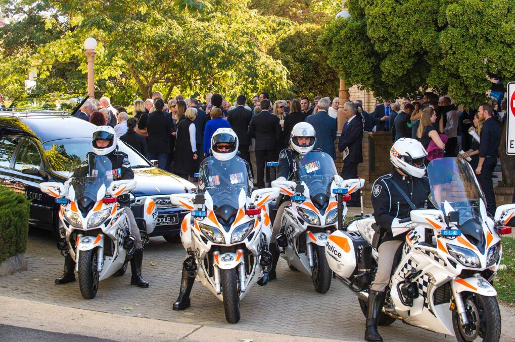 Sir Peter Lawler's cortege was escorted by police motorcyclists to the Woden cemetery. Photo: Sitthixay Ditthavong