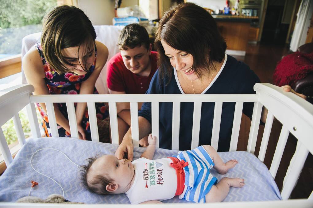 Three-month-old Charlie Clode with his family, Melissa, Lily (12), and William (14), at home in Bruce.  Photo: Rohan Thomson