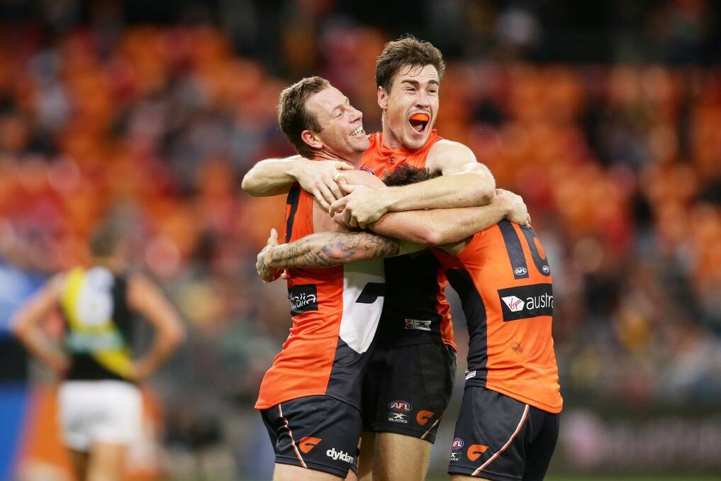 Victory, but at a cost: Steve Johnson (left) celebrates the Giants' miracle win over the Tigers with Jeremy Cameron. Photo: Getty Images
