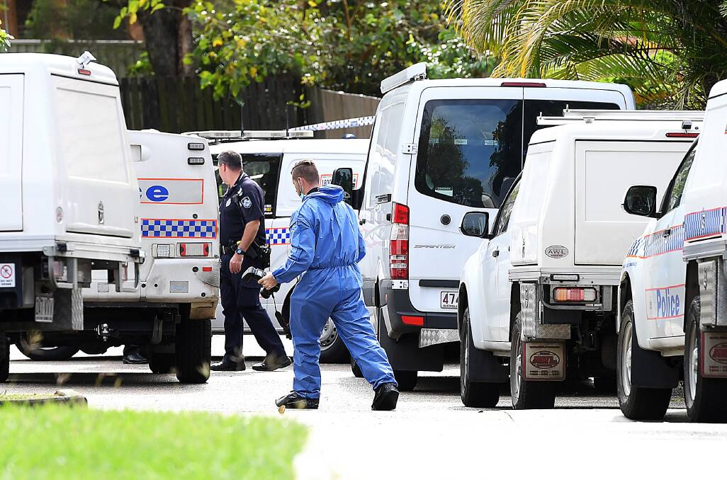 Scientific and forensic police officers scoured the Petrie street on Friday. Photo: AAP - Albert Perez