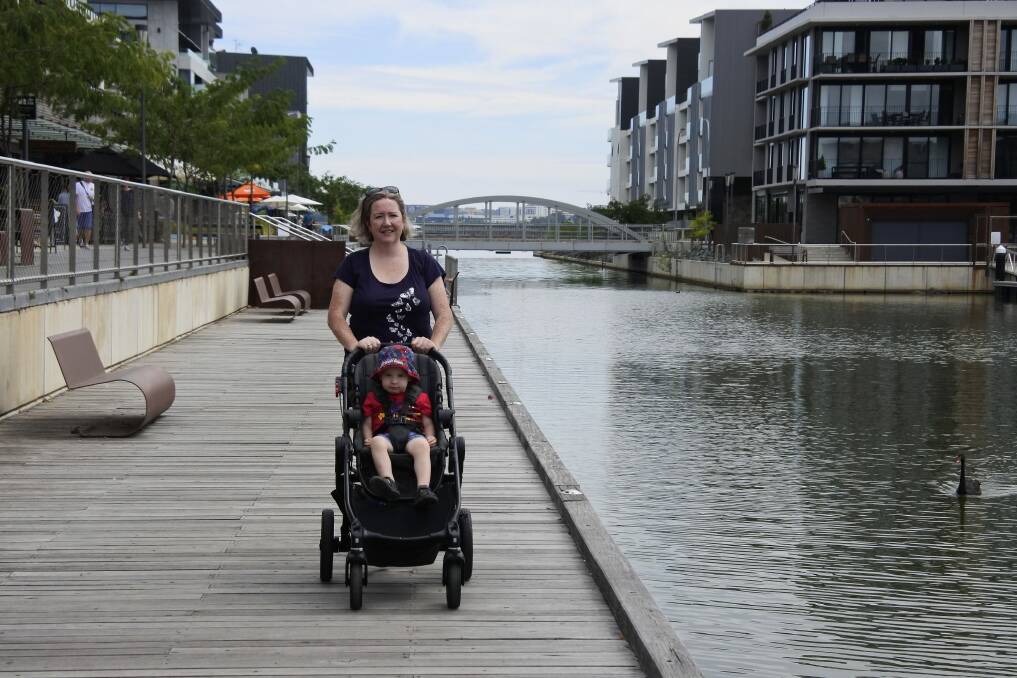 Anne O'Donoghue of Macgregor with son Liam, 2, at the Kingston Foreshore on Friday. She thinks a fence along the boardwalk would be a good idea. Photo: Megan Doherty