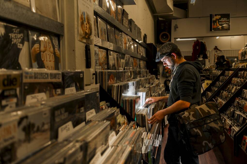 Local part-time DJ Colin McLeod looks through records at Landspeed Records in Garema Place. Photo: Rohan Thomson.