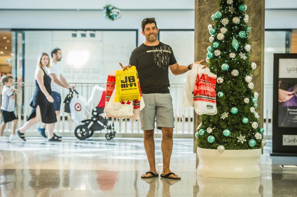 Dom Fusca taking the second load of shopping to the car as his wife shopped.  Photo: Karleen Minney