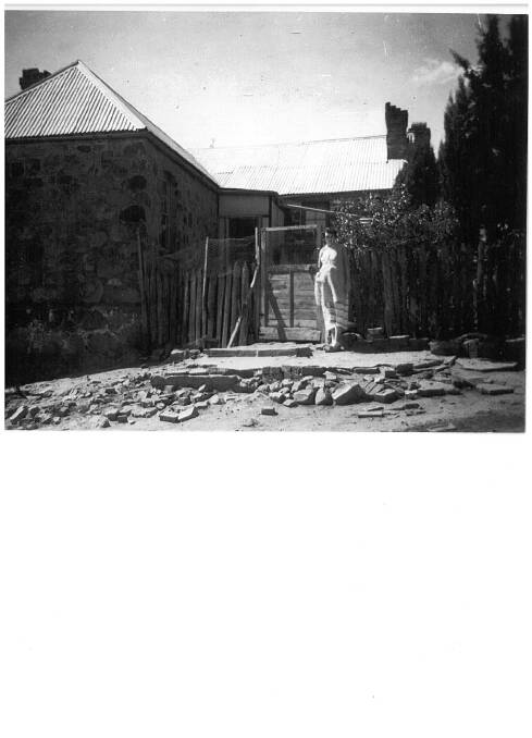 Mrs O'Brien outside Blundells Cottage in 1956. Mrs O'Brien boarded there with her husband. Photo: Supplied.