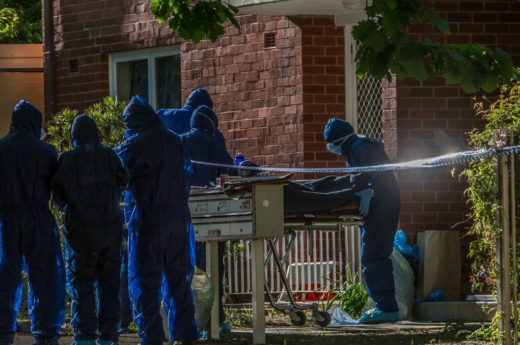 Police remove a dead body from a block of flats in Windeyer street Watson. Photo: Karleen Minney