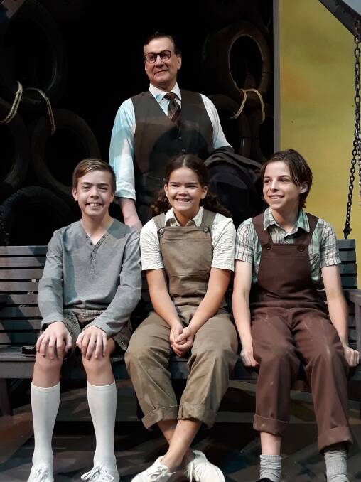 Michael Sparks as Atticus Finch with (sitting l-r)  Jamie Boyd as Jem, Jade Breen as Scout and Jake Keen as Dill on the set of To Kill a Mockingbird. Photo: Megan Doherty