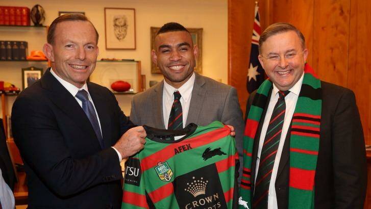 Prime Minister Tony Abbott is presented with a South Sydney jersey by Nathan Merritt and Labor MP Anthony Albanese. Photo: Andrew Meares