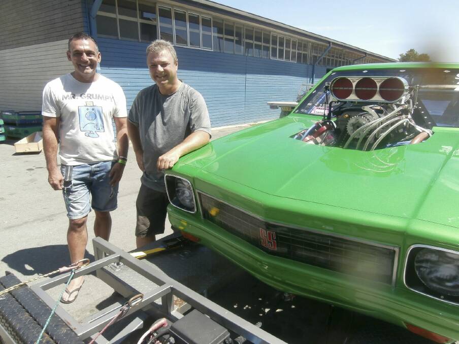 The morning after: Andy Lopez, Summernats co-owner, left, says good bye to Canberra's Brad Sullivan who brought his supercharged outlaw LX Torana SS to the event for the first time.  Photo: David Ellery 