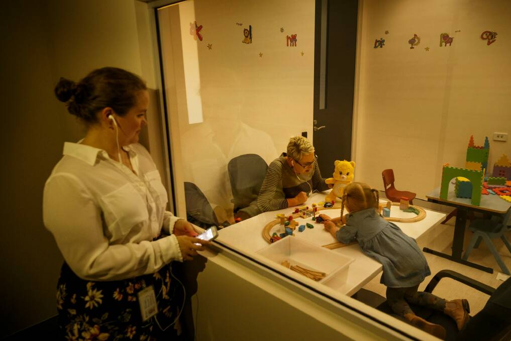 FACS psychologist Jessica Warren watches through a one-way mirror for PCIT. Photo: Max Mason-Hubers
