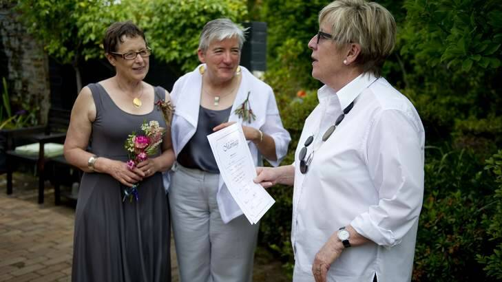Canberrans Margaret Penrose Clark and Anne-Marie Delahunt tie the knot, officiated by celebrant Judy Aulich. Photo: Jay Cronan