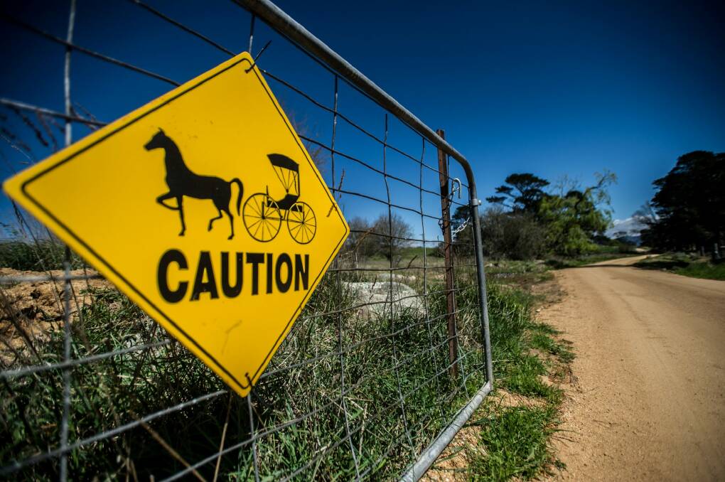 A sign on the gate hints at Antony Davies' passion for restoring horse-drawn vehicles. Photo: Karleen Minney