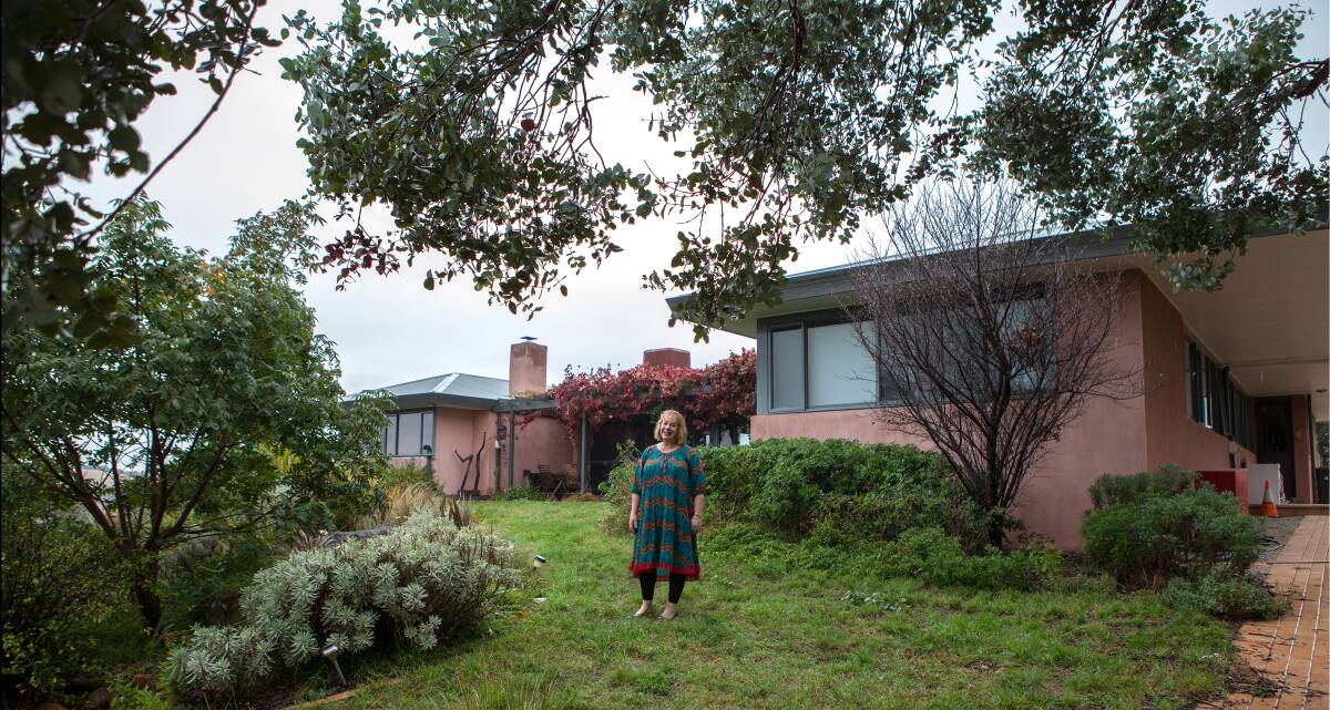 Dorothy Topfer at the Nerreman farm near the Cotter Dam. The homestead, contaminated with asbestos, is now demolished and the farm is for sale. Photo: Jennifer Nagy's 'More Than Bricks and Mortar, the many faces of Canberra's Mr Fluffy homes'.